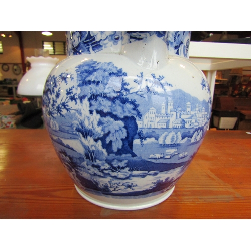 1003 - A 19th Century large blue and white jug with external figural scenes, chip to beak, 22cm tall