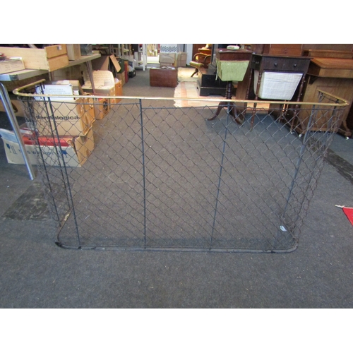 1010 - A brass and wire fire guard, 66cm tall x 115cm long x 30cm deep