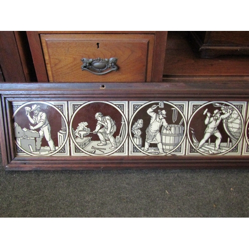 1011 - An oak framed set of nine Maw & Co. tiles depicting craftspeople, 146cm long