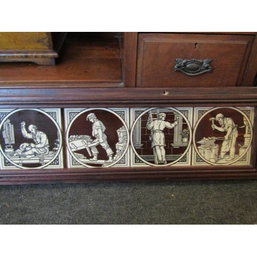 1011 - An oak framed set of nine Maw & Co. tiles depicting craftspeople, 146cm long