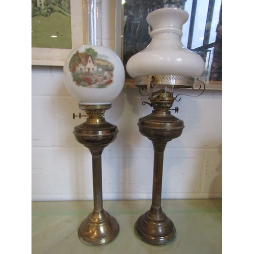 1018 - Two brass oil lamps with fluted stems and milk glass shades