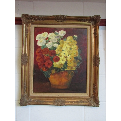 1022 - A 20th Century oil on board depicting a still life of chrysanthemums in pot.Indistinctly signed lowe... 