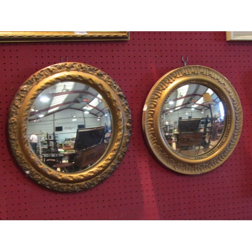 1059 - Two plaster gilt circular wall mirrors, largest 40cm diameter