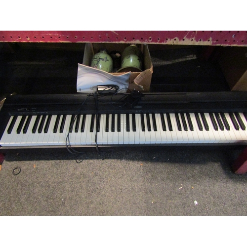 1060 - A Yamaha digital piano P-45 with power lead and owner's manual