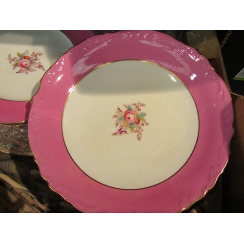 1075 - Two boxes containing a porcelain transferware part dessert set with pink borders and floral design, ... 