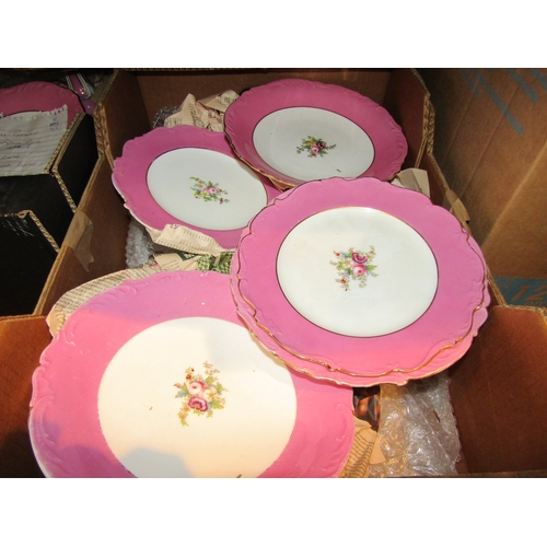 1075 - Two boxes containing a porcelain transferware part dessert set with pink borders and floral design, ... 