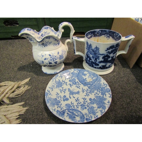 1077 - A box of blue and white ceramics including twin handled cup, vases, serving dish, ginger jar etc.