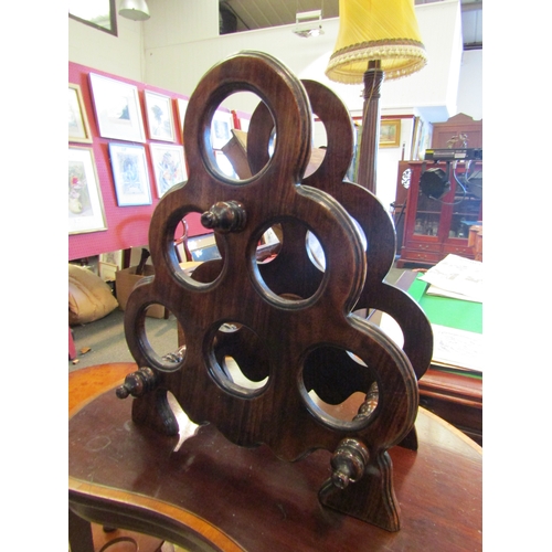 1099 - A mahogany six bottle wine rack with turned supports, 48cm tall x 40cm wide