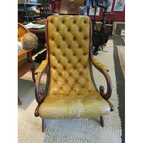 1110 - A leather button slipper chair with scrolled arms