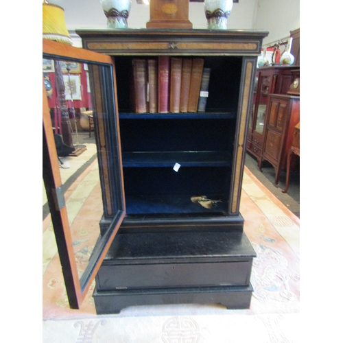 1113 - A Victorian ebonised pier cabinet with shelved interior on base with drop-flap and bracket feet, los... 