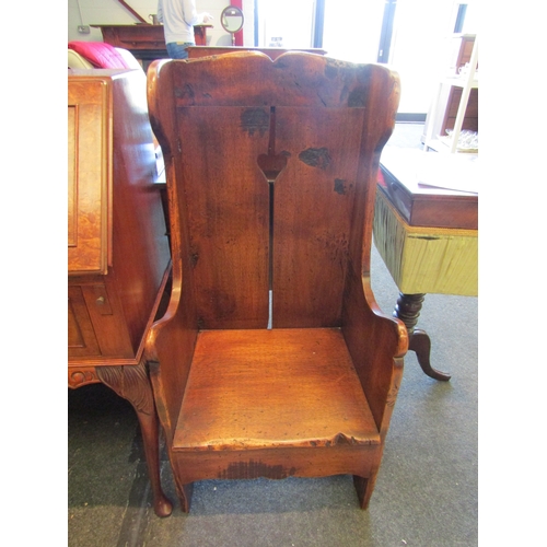 1139 - An 18th Century style oak lambing chair with heart shape cut out back, 97cm tall