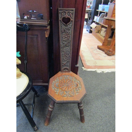 1150 - A carved oak Welsh spinner's chair with floral design