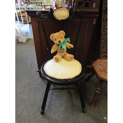 1151 - An ebonised spindle back side chair with a Merrythought teddy