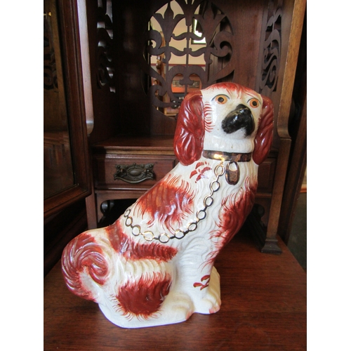 1153 - A pair of Staffordshire King Charles Spaniel figures, 25cm tall