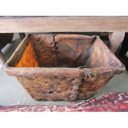 2052 - A rustic leather log basket