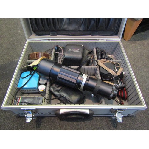 1206 - A camera travel case including two 35mm cameras and a quantity of lenses