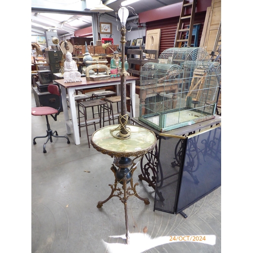 2030 - A Mid 20th Century brass and onyx floor lamp with centre table on hoofen feet