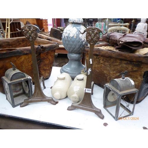 2051 - A pair of Art Nouveau coppered fire dogs and Two stone ware warmers and two lanterns