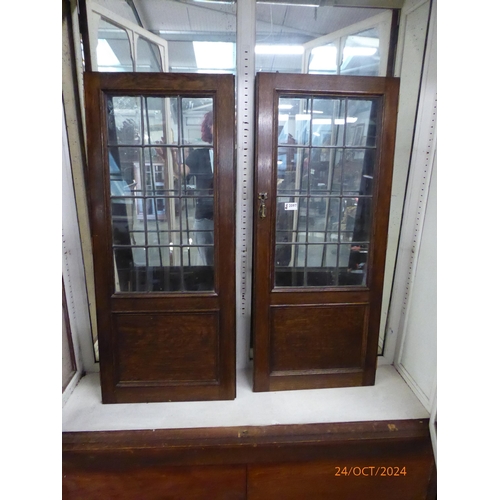 2097 - A pair of Edwardian oak and lead glazed cabinet doors one Payne cracked 44 x 102cm