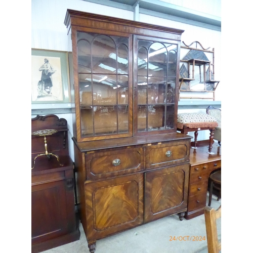 2111 - A Georgian flamed mahogany secretare bookcase with three trays to base