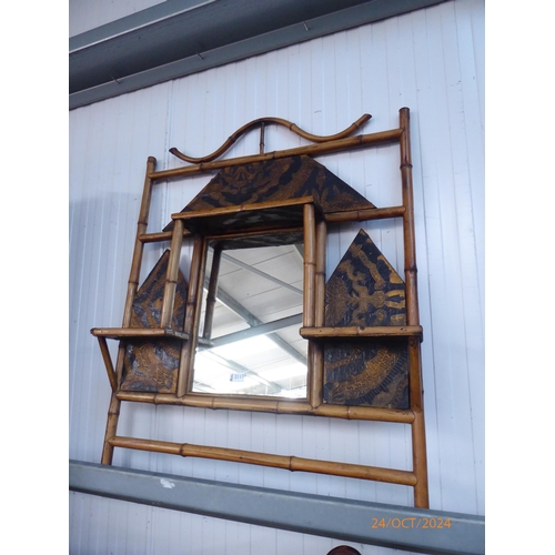 2117 - A faux bamboo wall mirror with black and gilt detailing and shelves, 98cm tall x 76cm wide