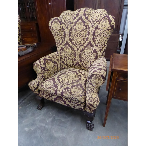 2171 - A substantial pair of Georgian style wingback armchairs with lion paw feet