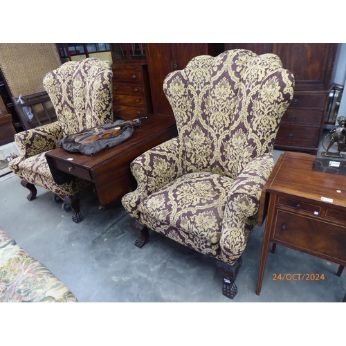 2171 - A substantial pair of Georgian style wingback armchairs with lion paw feet