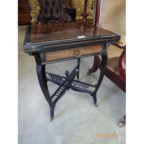 2180 - A 19th Century ebony and coramandel envelope games table