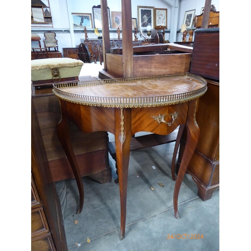 2189 - A French walnut demi-lune side table with brass gallery