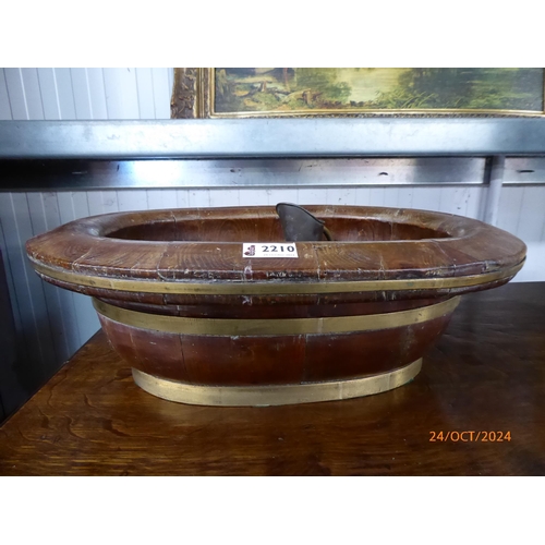 2210 - A barrel form bowl with miniature brass contents