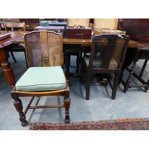 2218 - A 1930 / 40's oak draw-leaf dining table and four cane back chairs