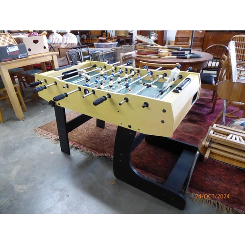 2435 - A folding football table, 79cm x 112cm x 62cmn