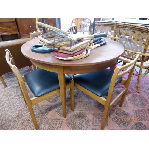 2436 - A 1970's teak extending circular dining table and four chair frames