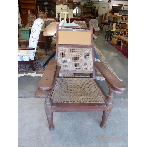 2449 - A harwood and cane back plantation chair