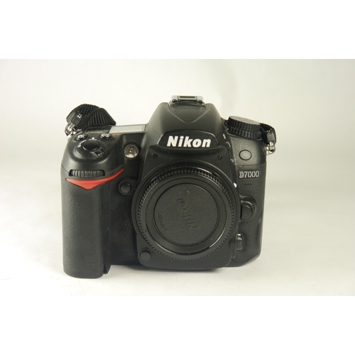 6069 - A Nikon D7000 DSLR camera w/n=Nikon AF Nikkor 70-300mm 1:4-5.6g zoom lens & Nikon MB-D11 motordrive.... 