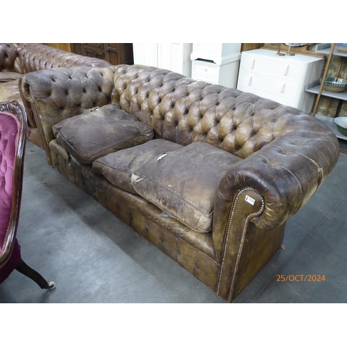 An early 20th Century brown button leather Chesterfield sofa for