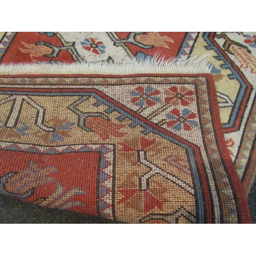 1043 - A terracotta ground rug with multiple borders and central panel, 132cm x 86cm