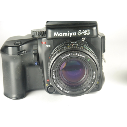 6004 - A Mamiya 645 Pro TL Medium Format 120 film camera w/ Mamiya AE Metered Prism Finder FK402 & Power Dr... 