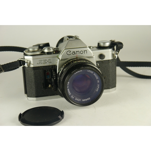 6100 - A Canon AE-7 W/Sirus and Ozick lenses **battery holder damaged**