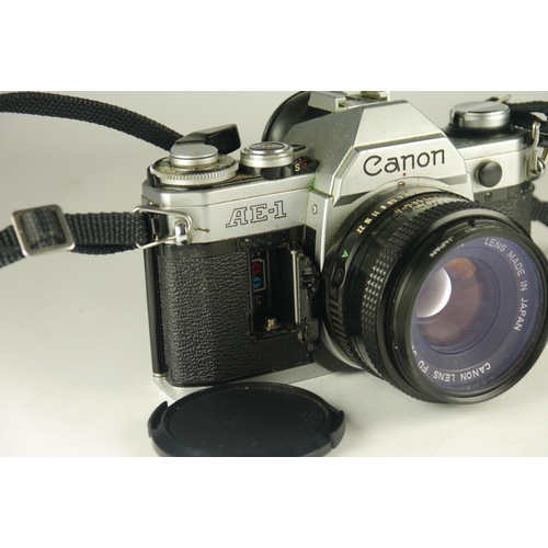 6100 - A Canon AE-7 W/Sirus and Ozick lenses **battery holder damaged**