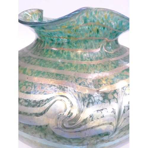 7267 - A large iridescent mottled green glass vase with waved rim. 22cm high x 34cm diameter