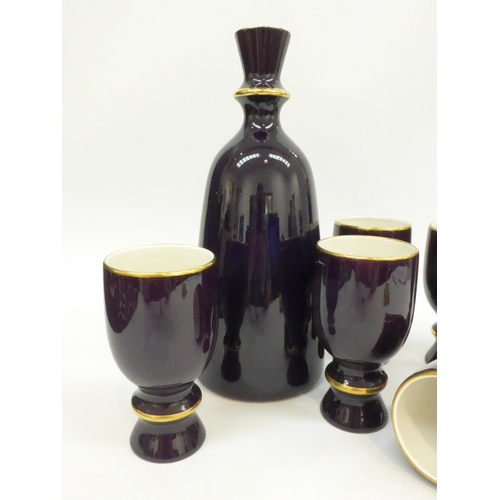 7093 - A Carlton Ware pottery cobalt blue decanter and six goblets with gold detail, decanter 30.5cm high