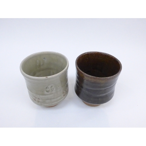 7115 - Two studio pottery yunomi with impressed potters seal, tallest 11cm