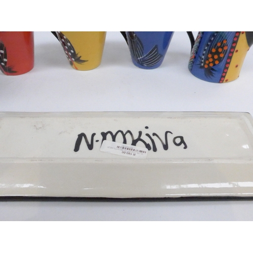 7029 - A collection of studio pottery with colourful hand painted decoration, painted 'NM' initials to base... 