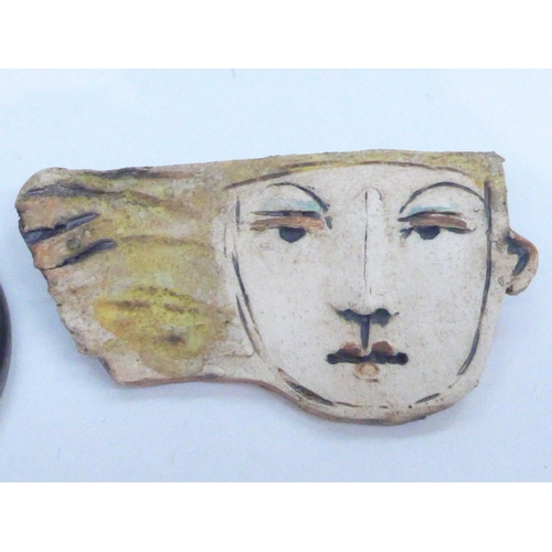 7341 - A Christy Keeney studio pottery brooch in the form of a head, and a Leaper Pottery of Cornwall studi... 