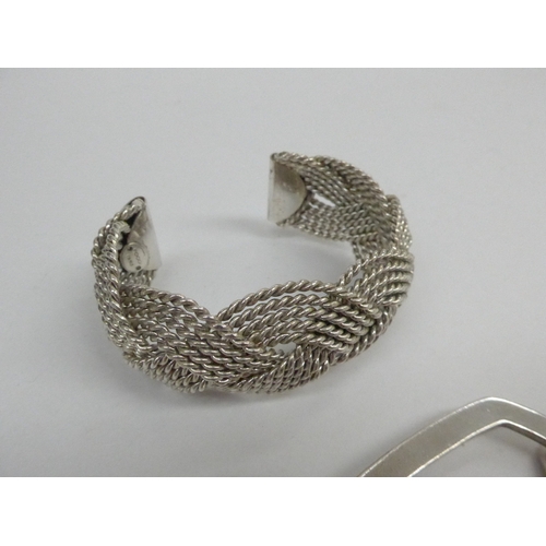 7351 - A silver bangle, woven cuff bracelet and square link bracelet