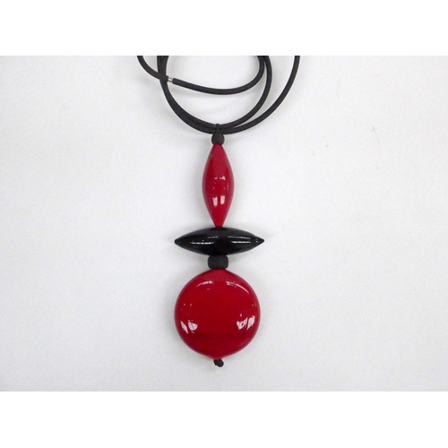 7361 - A modern necklace with three large laquered bead drops hung on a hollow rubber double necklet