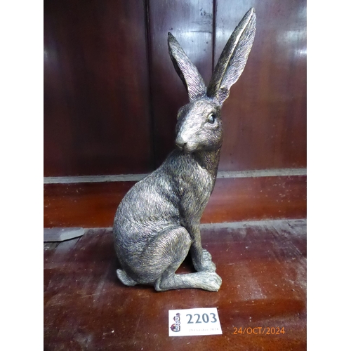 4080 - A bronzed resin statue of a sitting hare, 22cm tall