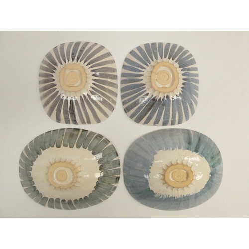 7104 - MADOLINE KEELER (1942-) four white earthenware bowls individually patterned.  Potters impressed mark... 