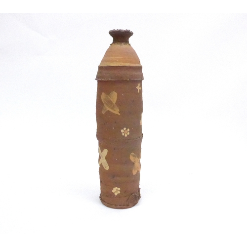 7140 - PETER SMITH (1941) A studio pottery bottle form vase with painted crosses and flowers. Impressed sea... 